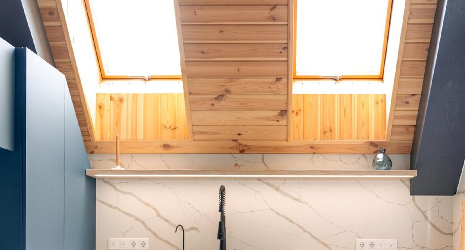 A vaulted loft room with skylights